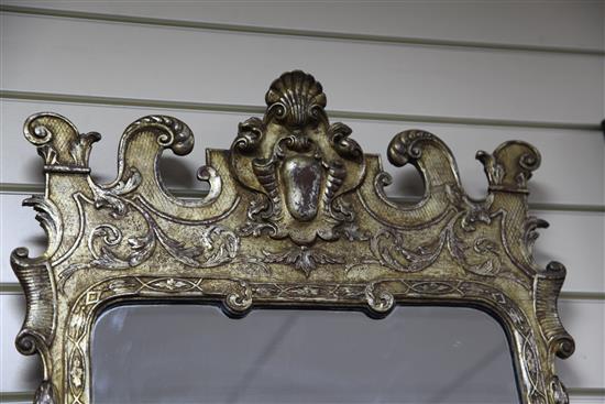 A George II style carved silvered wood framed wall mirror, Height 3ft 1in. Width 1ft 8in. H.3ft 1in.